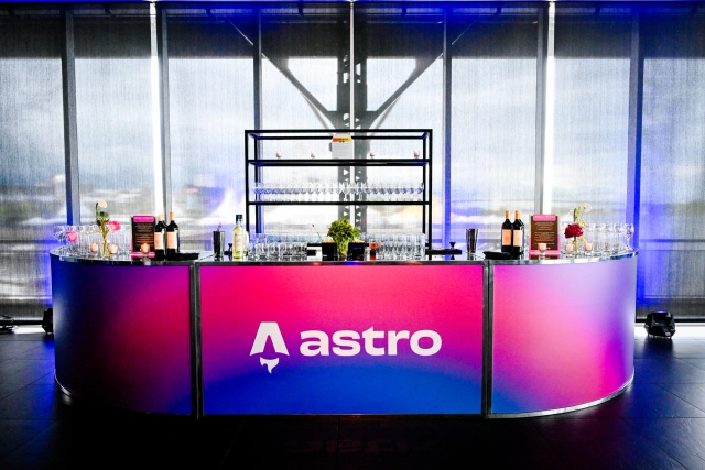 Vibrant blue and red alcohol bar with the Astro logo across it in white.