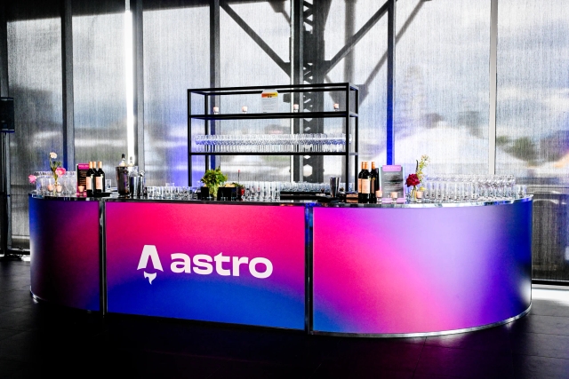 Vibrant blue and red alcohol bar with the Astro logo across it in white.