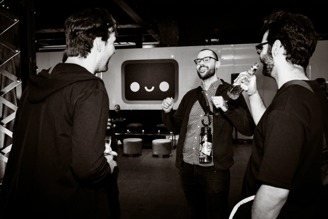 Black and white photo of Fred, steward of the Astro project, laughing with guests.