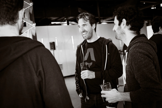 Black and white photo of Fred, steward of Astro, laughing with guests.