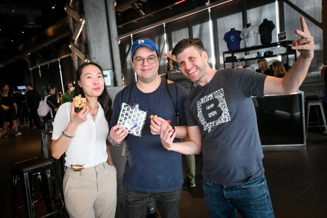 Guests posing with a representative from Storyblok.