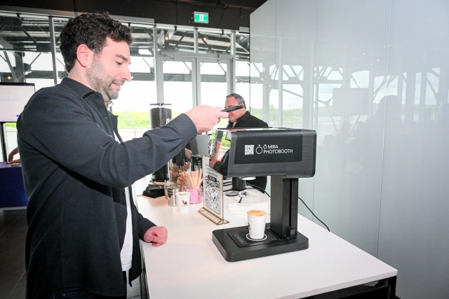 A male guest using the coffee printing machine.