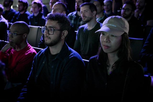 Audience members listening intently to the keynote presentation.