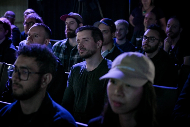 Audience members listening intently to the keynote presentation.