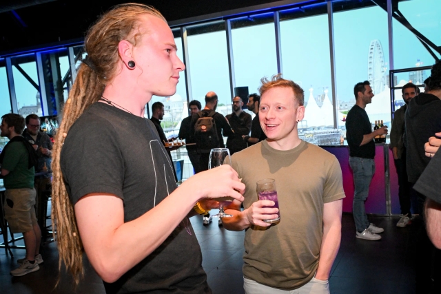 Elian, of Astro, chatting with David Di Biase, of Solid. Both men hold drinks.