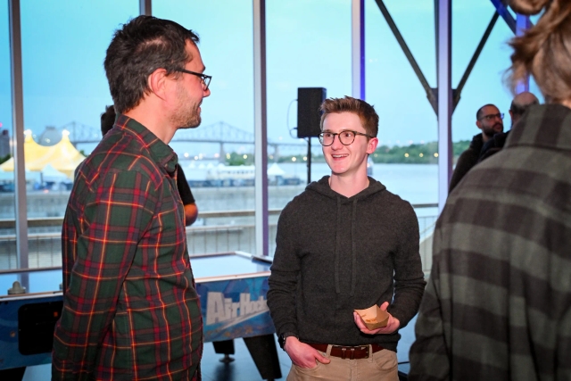 Ben Holmes smiles as he chats with a guest.